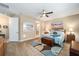 Main bedroom with large window, wood flooring, and en-suite bathroom at 7646 Sw 100Th Ct, Ocala, FL 34481