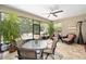 Bright screened porch with outdoor furniture and plants at 7646 Sw 100Th Ct, Ocala, FL 34481