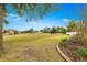 Open backyard with grassy area and partially visible neighboring homes at 7977 Sw 85Th Loop, Ocala, FL 34476