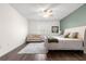 Main bedroom with king bed, ceiling fan, and accent wall at 7977 Sw 85Th Loop, Ocala, FL 34476