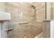 Walk-in shower with tiled walls, built-in seat, and dual shower heads at 7977 Sw 85Th Loop, Ocala, FL 34476