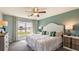 Bright bedroom with lake view, featuring a comfortable bed and stylish decor at 8503 Las Palmas Way, Wildwood, FL 34785