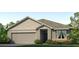 One-story home with gray siding, gray roof, and a two-car garage at 8511 Las Palmas Way, Wildwood, FL 34785