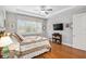 Bright bedroom featuring hardwood floors, ceiling fan, and large window at 8749 Sw 93Rd Cir, Ocala, FL 34481