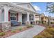 Front porch with stone pillars, red shutters, and wicker seating at 8749 Sw 93Rd Cir, Ocala, FL 34481