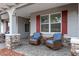 Relaxing front porch with wicker chairs and a side table at 8749 Sw 93Rd Cir, Ocala, FL 34481