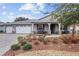 One-story house with a three-car garage and landscaped yard at 8749 Sw 93Rd Cir, Ocala, FL 34481