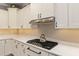 Stylish kitchen with gas cooktop, white shaker cabinets, and penny tile backsplash at 8749 Sw 93Rd Cir, Ocala, FL 34481