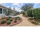 Landscaped garden path with manicured shrubs and gravel at 8749 Sw 93Rd Cir, Ocala, FL 34481