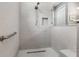 Walk-in shower with tiled walls and grab bars at 8749 Sw 93Rd Cir, Ocala, FL 34481