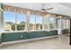 Sunroom with white plantation shutters and a view of the backyard at 8749 Sw 93Rd Cir, Ocala, FL 34481