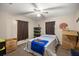 Bedroom with double bed, ceiling fan, and storage boxes at 876 Ne 71St Ln, Ocala, FL 34479