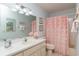 The bathroom has a shower with a pink curtain and an elongated countertop with a sink at 9051 Sw 96Th Ln # B, Ocala, FL 34481
