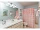 Charming bathroom featuring a vanity sink and a tub with a floral shower curtain at 9051 Sw 96Th Ln # B, Ocala, FL 34481