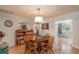 Dining room with hardwood floors, round wooden table and chairs, and a decorative chandelier at 9051 Sw 96Th Ln # B, Ocala, FL 34481