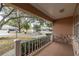 Covered porch offers a view of the community and surrounding trees at 9051 Sw 96Th Ln # B, Ocala, FL 34481