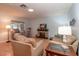 Comfortable living room featuring neutral tones, laminate flooring, and a decorative fireplace at 9051 Sw 96Th Ln # B, Ocala, FL 34481