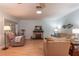 Comfortable living room with plush seating, brick fireplace, and hardwood floors at 9051 Sw 96Th Ln # B, Ocala, FL 34481