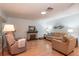 Inviting living room featuring a cozy fireplace, hardwood floors, and comfortable furnishings at 9051 Sw 96Th Ln # B, Ocala, FL 34481