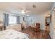 Bright main bedroom with wood flooring, featuring a ceiling fan and comfortable furniture at 9051 Sw 96Th Ln # B, Ocala, FL 34481