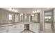 Double vanity bathroom with granite countertop and large mirror at 9253 Sw 86Th Pl, Ocala, FL 34481