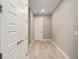 Bright hallway with wood-look floors and doors at 9253 Sw 86Th Pl, Ocala, FL 34481