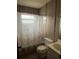 Bathroom with shower/tub, toilet, vanity, and seashell-themed curtain at 9359 Bahia Rd, Ocala, FL 34472