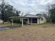 House exterior showcasing carport and yard at 9359 Bahia Rd, Ocala, FL 34472