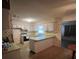 Galley kitchen with white cabinets and vinyl flooring at 9359 Bahia Rd, Ocala, FL 34472