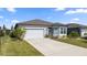 Front view of a one-story house with a garage and landscaping at 9411 Sw 54Th St, Ocala, FL 34481