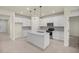 Modern kitchen with white cabinets, center island, and stainless steel appliances at 9411 Sw 54Th St, Ocala, FL 34481