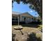 One-story house with gray siding, a covered entryway, and a landscaped lawn at 9794 Sw 96Th St, Ocala, FL 34481