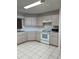 Kitchen features white appliances and ample counter space at 9794 Sw 96Th St, Ocala, FL 34481