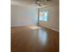 Spacious living room with laminate wood flooring and ceiling fan at 9794 Sw 96Th St, Ocala, FL 34481