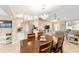 Bright dining area with wood table and chairs, view into living room and kitchen at 10628 Sw 74Th Ave, Ocala, FL 34476