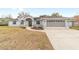 Two-car garage and gray house exterior with driveway at 10628 Sw 74Th Ave, Ocala, FL 34476