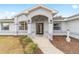 Front entryway with arched entry, gray columns, and landscaping at 10628 Sw 74Th Ave, Ocala, FL 34476