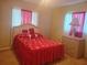Cozy bedroom featuring a wicker bed frame, matching dresser, and bright accents at 10800 Sw 62Nd Ave, Ocala, FL 34476