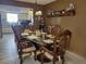 Elegant dining room with wood table and chairs, kitchen view at 10800 Sw 62Nd Ave, Ocala, FL 34476