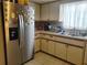 Stainless steel refrigerator and white cabinetry in this kitchen at 10800 Sw 62Nd Ave, Ocala, FL 34476