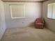 Bedroom with light carpeting, a pink chair and window blinds at 10829 Sw 83Rd Ave, Ocala, FL 34481