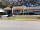 Front view of a ranch-style home with a well-maintained lawn at 10829 Sw 83Rd Ave, Ocala, FL 34481