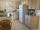 Updated kitchen with white appliances and a breakfast bar at 10829 Sw 83Rd Ave, Ocala, FL 34481