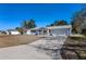 Exterior view of a house with driveway and lawn at 11253 Sw 77Th Ct, Ocala, FL 34476