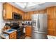 Modern kitchen with stainless steel appliances and wood cabinets at 11253 Sw 77Th Ct, Ocala, FL 34476