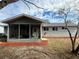 House exterior showcasing a screened porch and landscaped yard at 11440 Sw 85Th Ave, Ocala, FL 34481