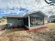 House exterior showcasing a screened porch and landscaped yard at 11440 Sw 85Th Ave, Ocala, FL 34481