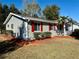 Gray sided home with red shutters, and well manicured landscaping at 11440 Sw 85Th Ave, Ocala, FL 34481