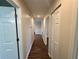 Long hallway with light walls and hardwood floors at 11440 Sw 85Th Ave, Ocala, FL 34481