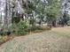 Backyard with lush landscaping and trees at 11577 Sw 72Nd Cir, Ocala, FL 34476